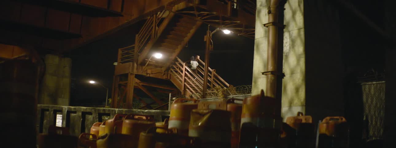 Person walking up the stairs in an industrial area