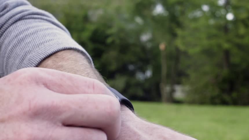 Person looks at their watch and sets it