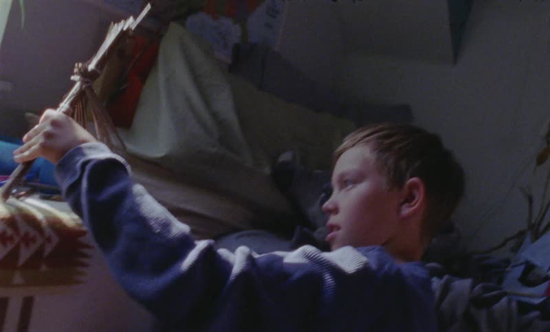 A boy is playing in his bedroom