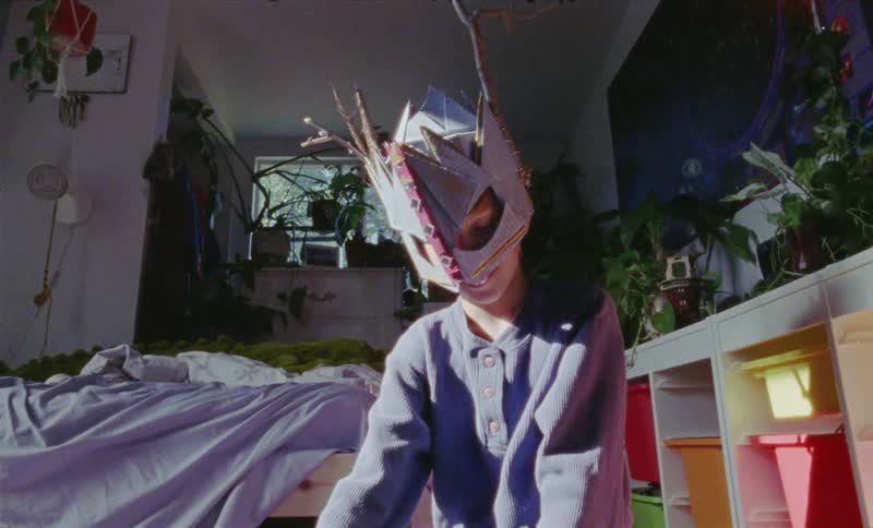 Child wears a mask and plays in the bedroom