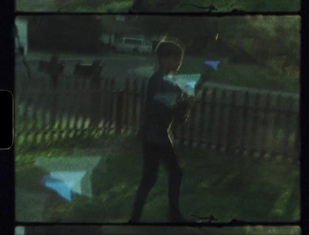 Child swings a bat to hit a ball and runs with a dog chasing him