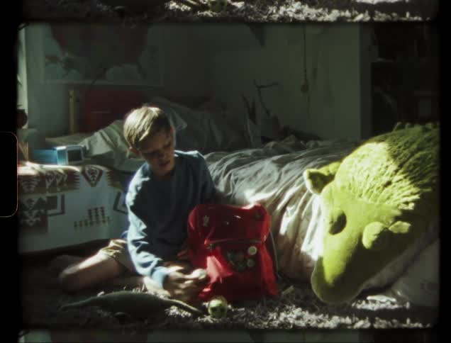 A young child plays in his bedroom