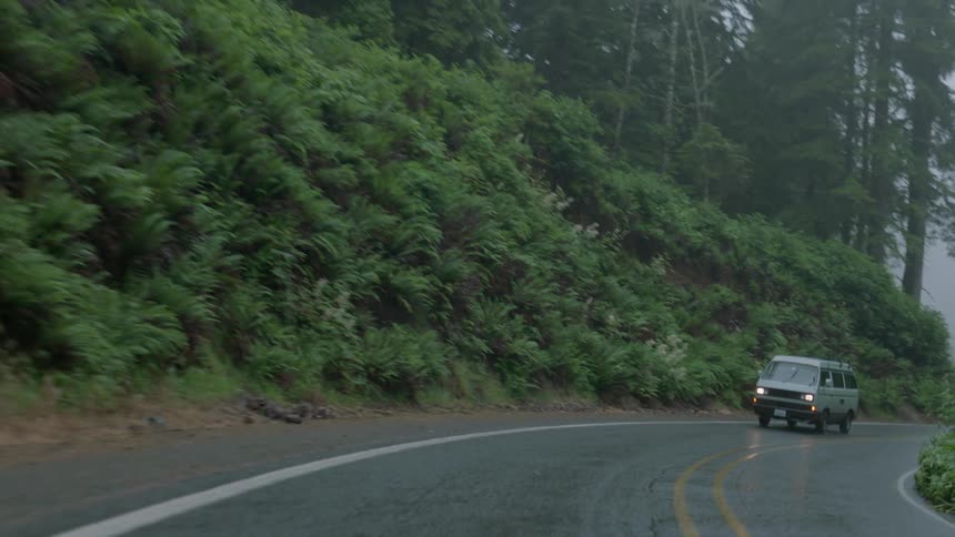 A van drives on the rainy road