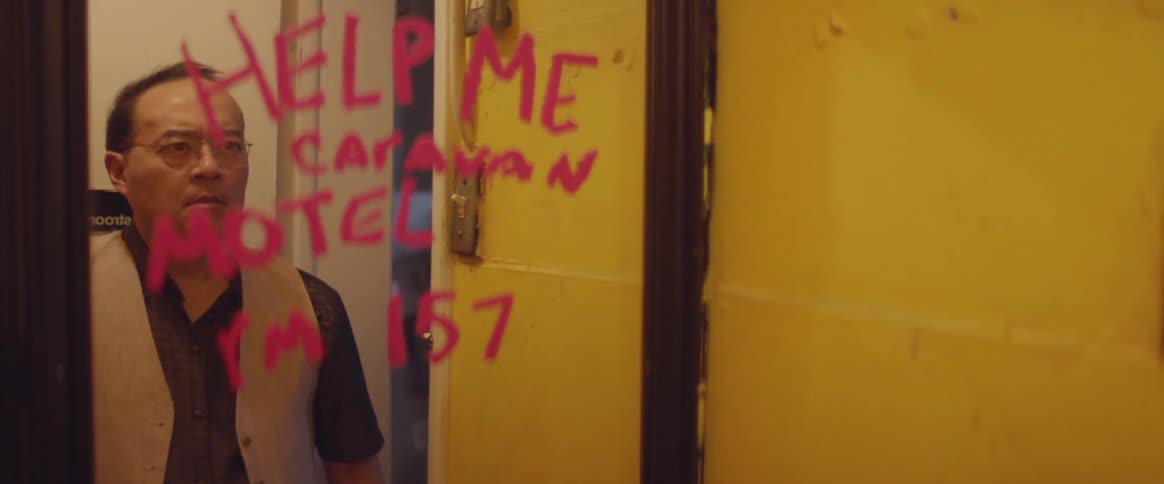 Man looks scared to see a message written on a mirror