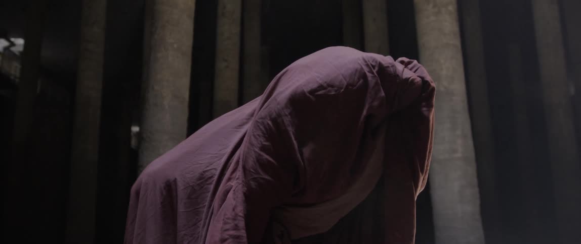 Person covered in fabric moves it around