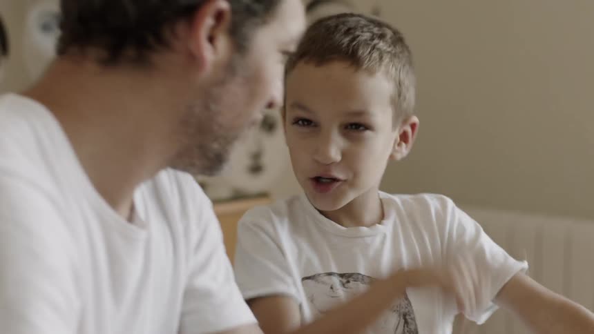 Child talks and smiles at a man