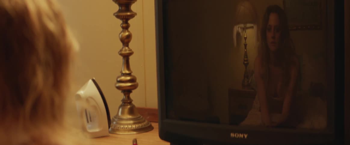 Woman is reflected in a television screen