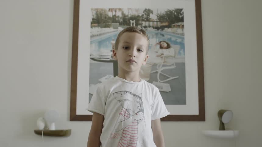 Child stands in front of a picture