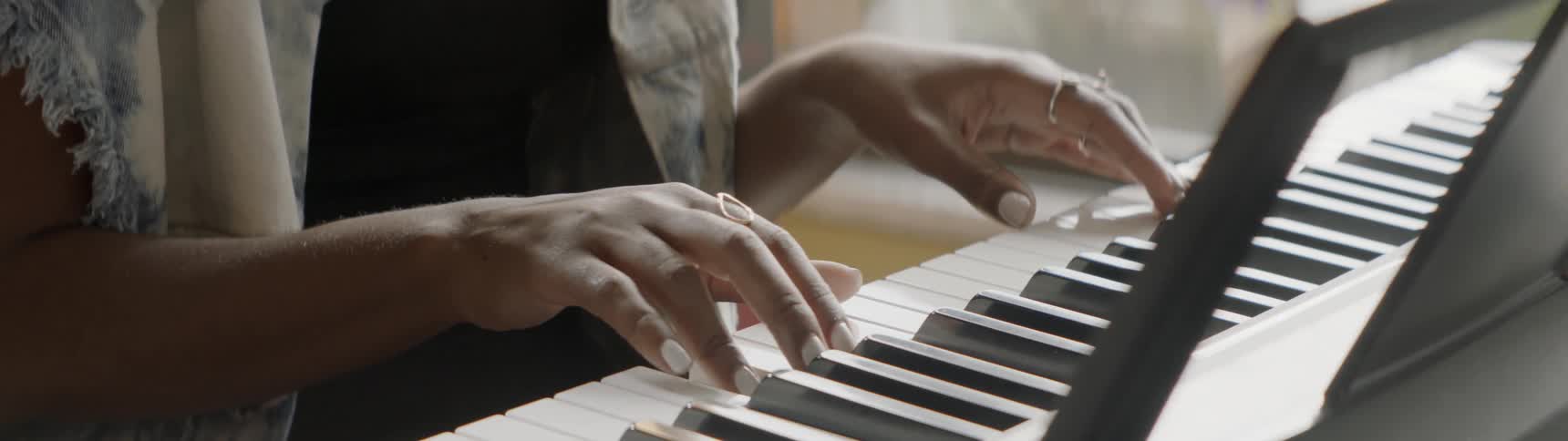Person plays a keyboard on a sunny day