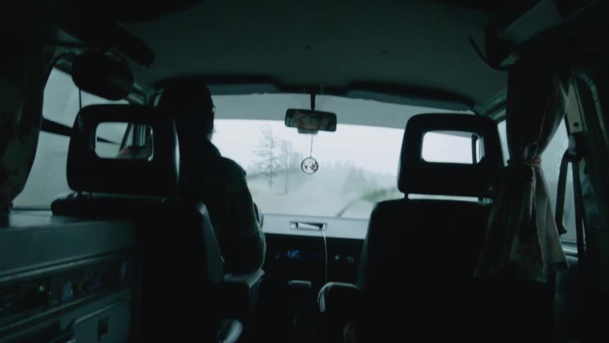 A man drives on a rainy day