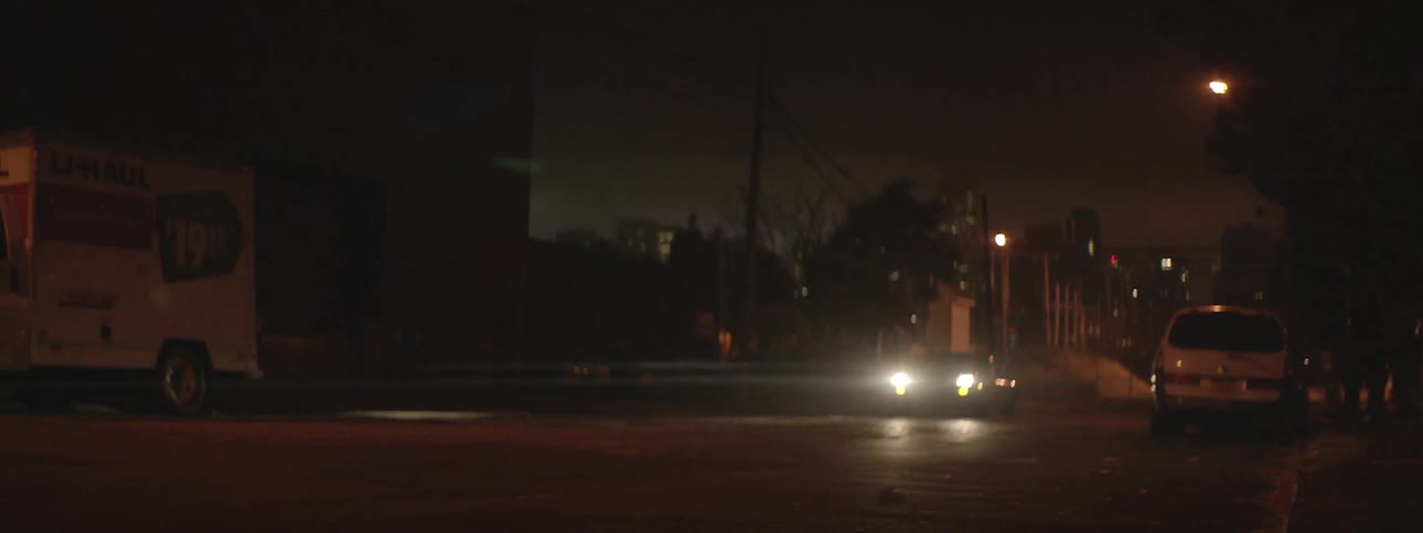 A car driving down a road at night