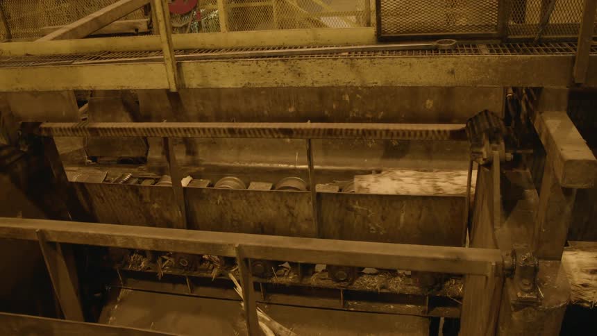 Machinery is running in a logging mill during the day
