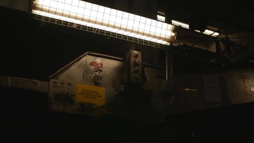 An overhead industrial light shines on equipment