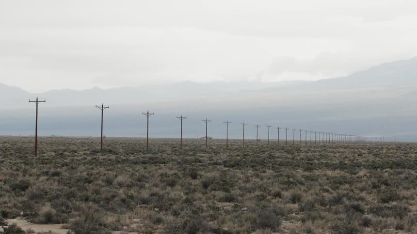 Power lines run across a rural field