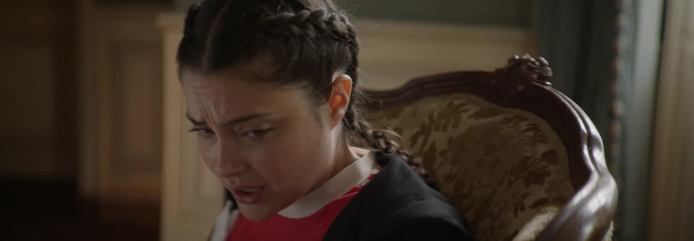 Worried looking woman gets up from a chair