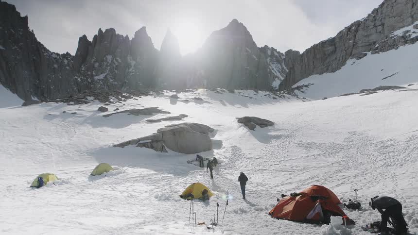 Backpackers are camping on snow covered mountain