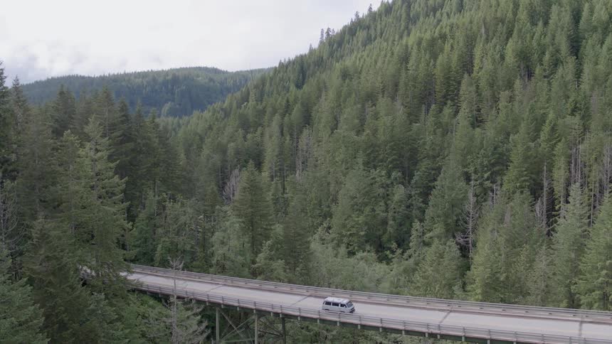 Car travels on a mountain bridge