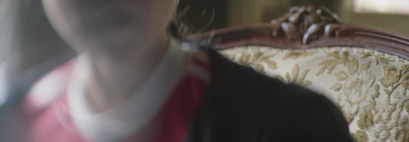 Person sits in a chair breathing heavily