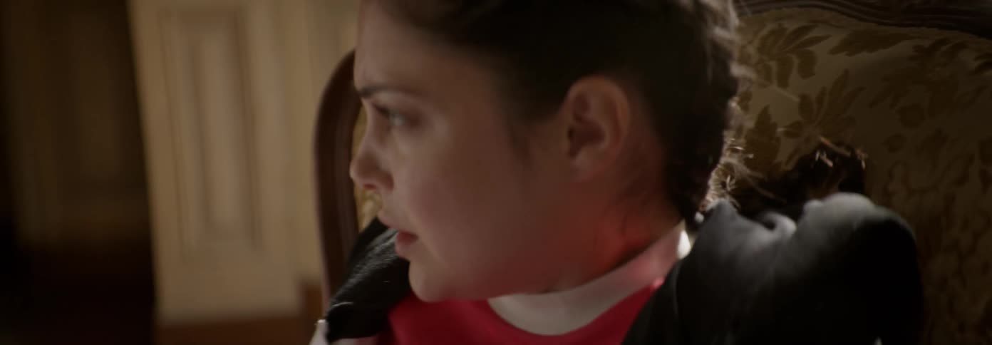 Woman looks frightened as she sits in a chair