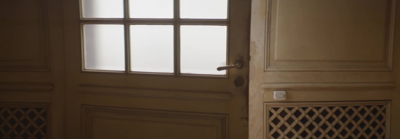 A house door sits cracked open