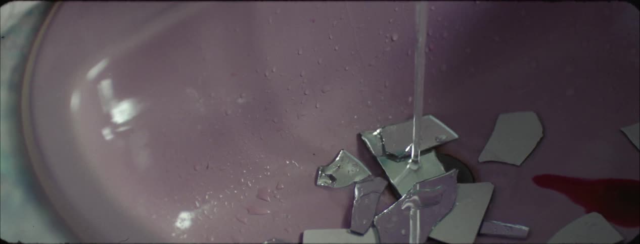 Glass falls into a running sink
