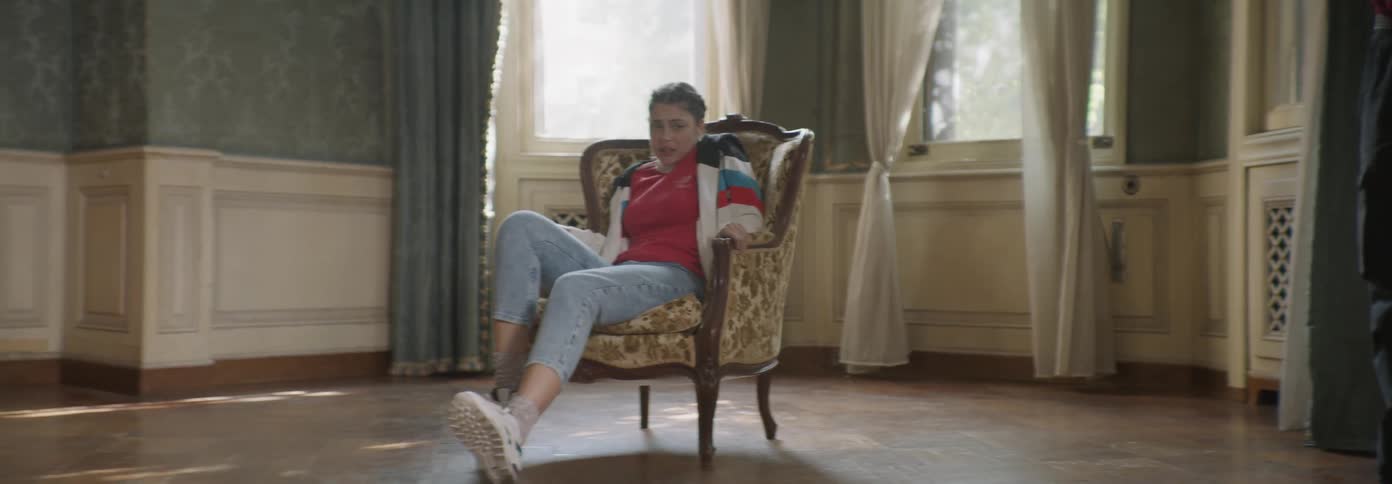 Woman sits in a chair breathing heavily