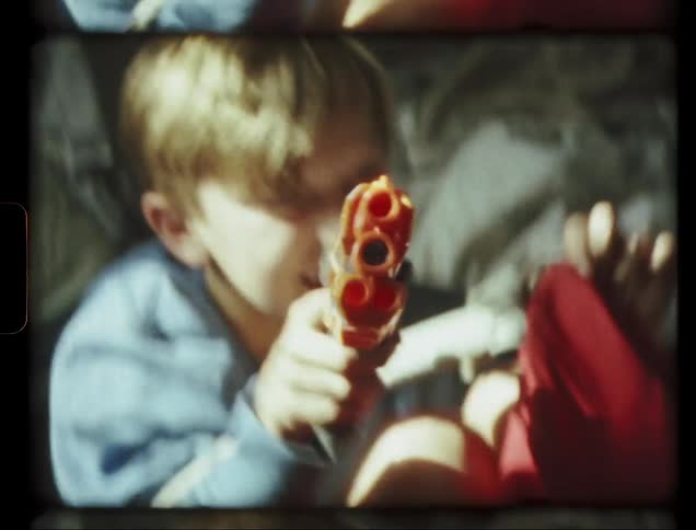 Boy plays with a toy gun