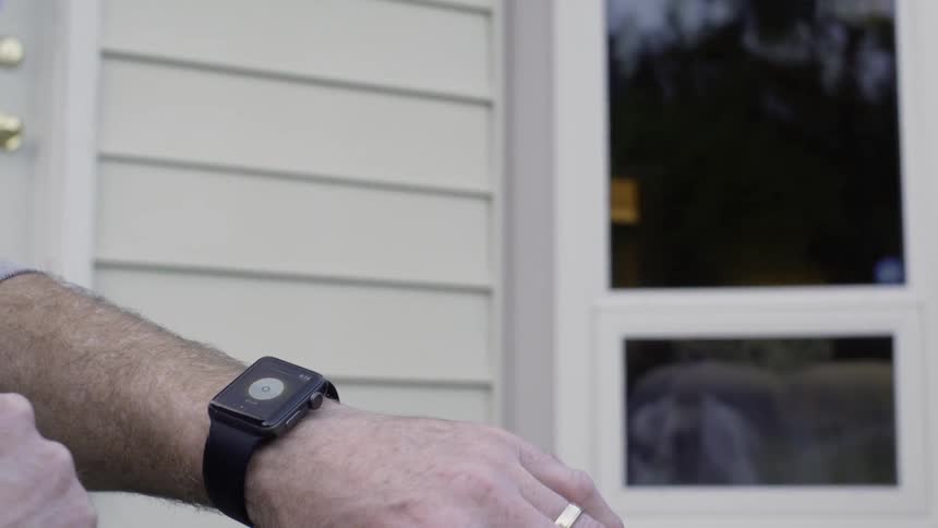 Man presses button on smartwatch on his wrist