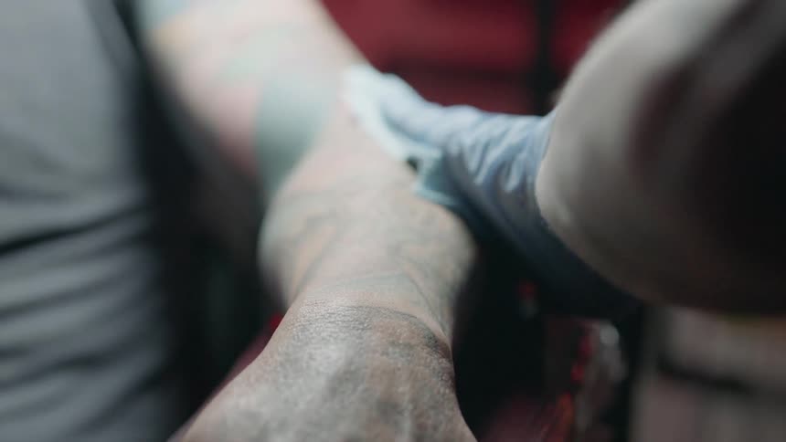 Person wipes another person's arm