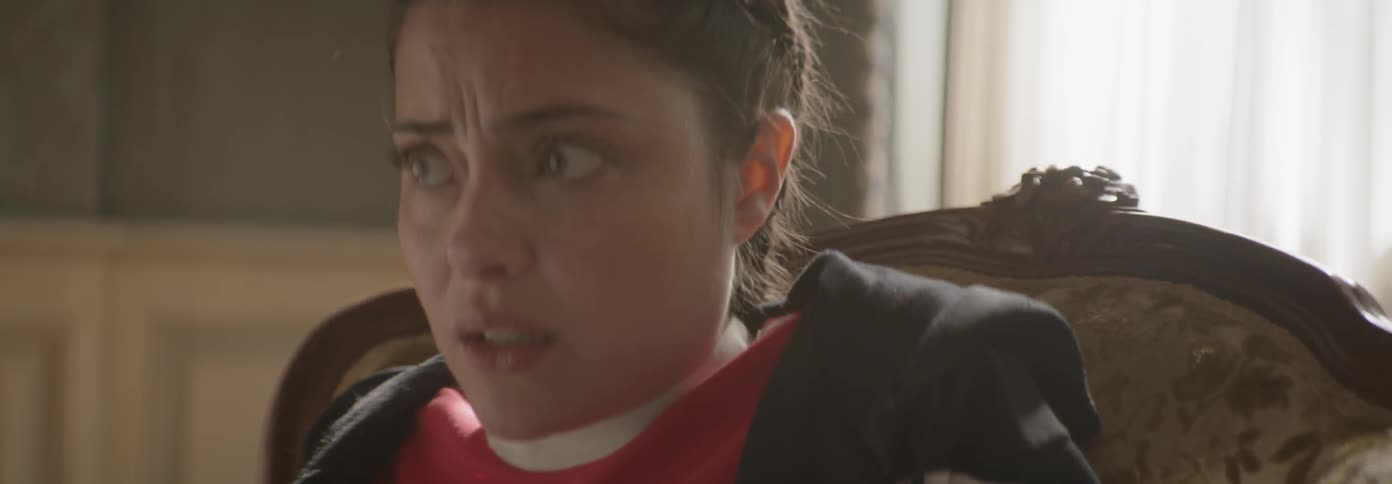 Worried looking girl looks around sitting in a chair