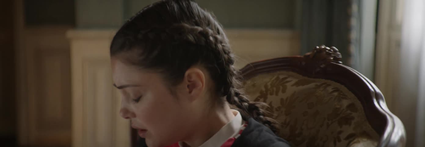 A woman sitting in a chair looks around the room and becomes agitated