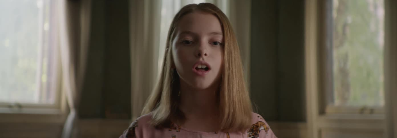 Child standing in front of a window nodding and talking