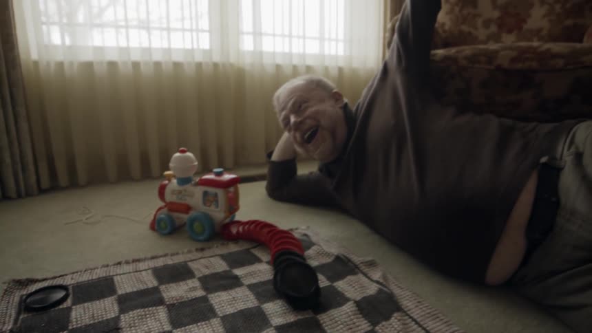 A man plays checkers with a young boy