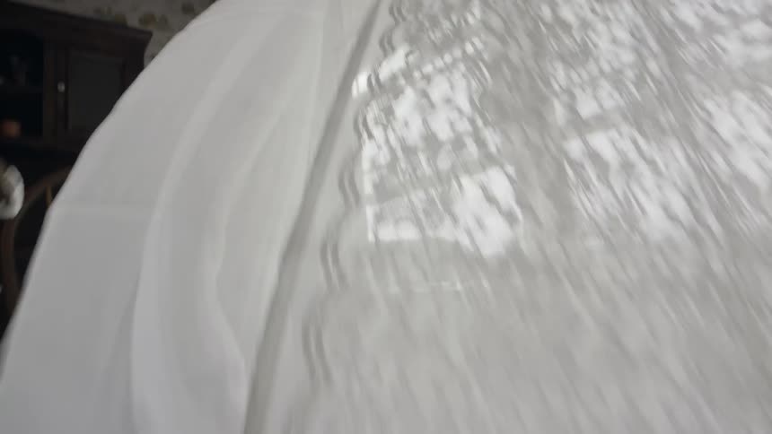Wind blows through window curtains