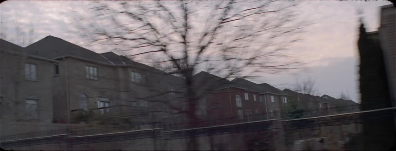 Many houses and buildings in a city at sunset