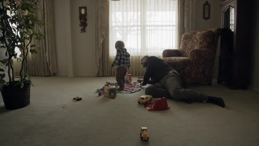Toddler and father play in living room