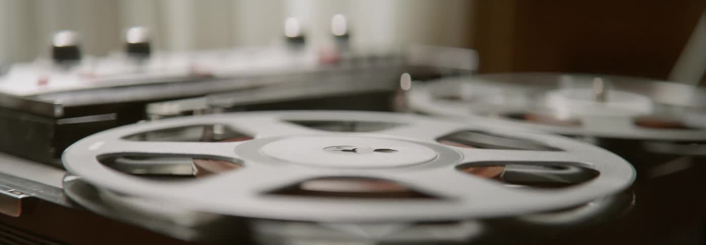 Two movie reels rotate around