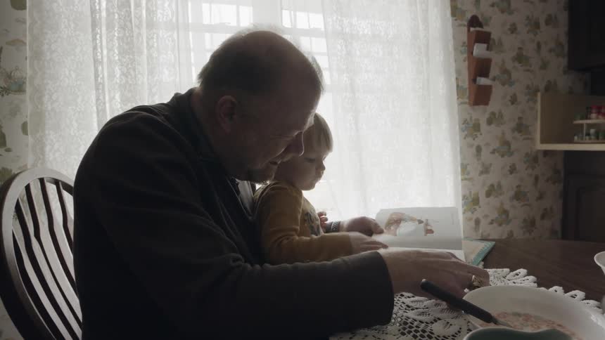A man reads to a young child