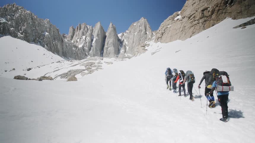 A group hike up a snowy mountain