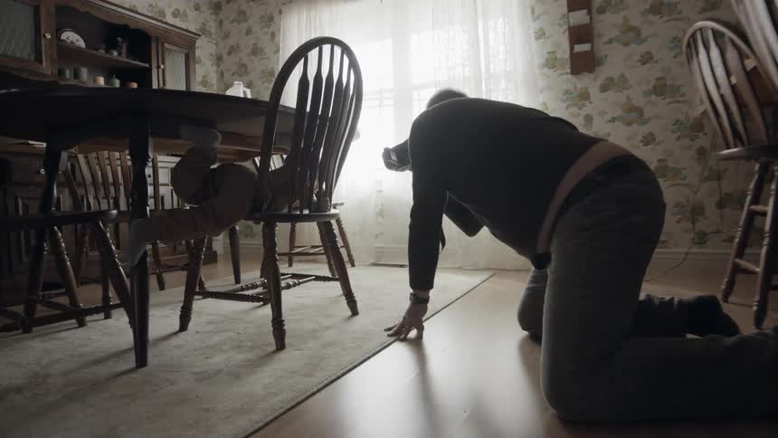 Elderly man records a toddler climbing on chairs
