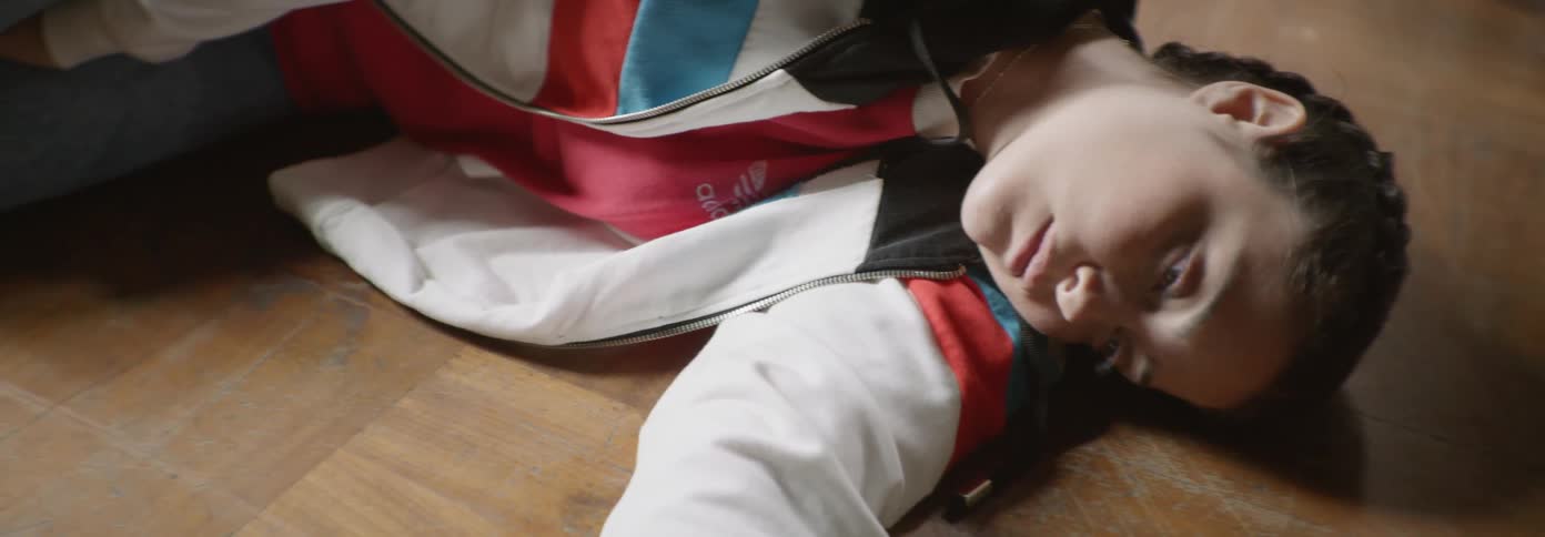 Young boy lays on the floor as he blinks his eyes
