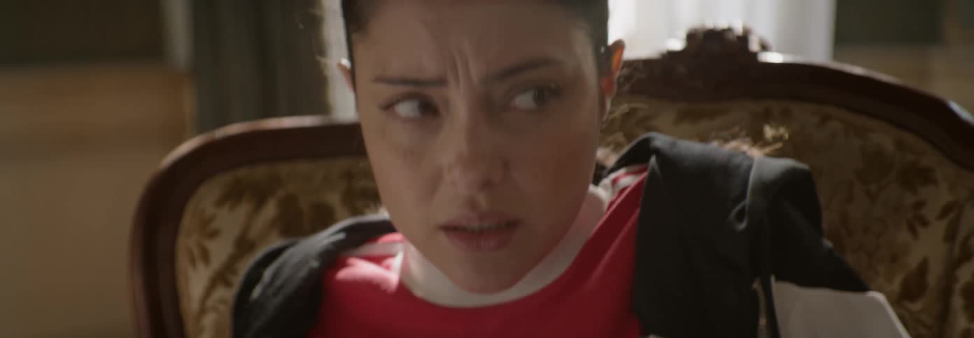 Woman breathes heavily while sitting in a chair