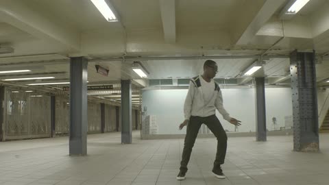 Boy dancing inside of a subway