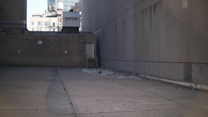Debris blowing around in the wind on concrete