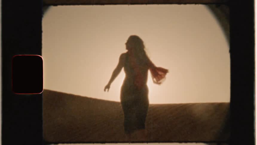 Woman climbs sand dune