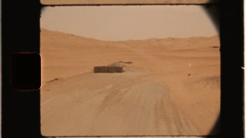 Car drives on a desert road