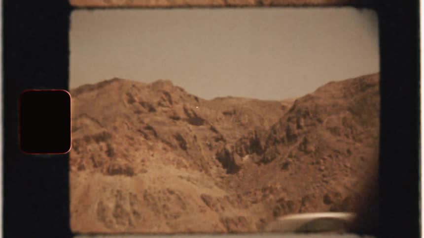 Cars pass on the road by the mountain