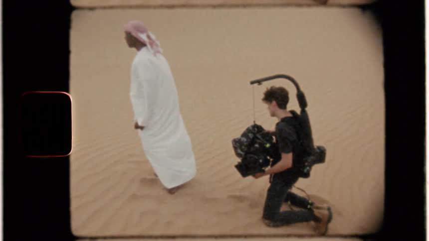 Man records a man standing in the desert