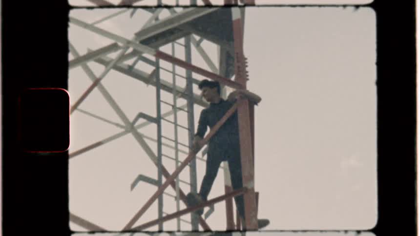 A man climbs on a radio tower