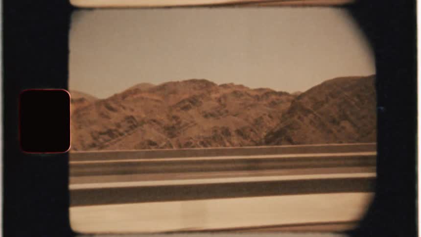 Car drives on a road near mountains